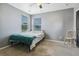 Simple bedroom features carpet flooring, a window with blinds, and a ceiling fan at 9919 Memphis St, Commerce City, CO 80022