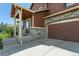A close up of the front exterior with a view of the garage and entryway at 9919 Memphis St, Commerce City, CO 80022