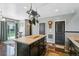 Functional kitchen space with a center island and dark wood cabinets at 9919 Memphis St, Commerce City, CO 80022