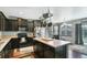 This kitchen boasts a large island, dark cabinetry, and modern appliances at 9919 Memphis St, Commerce City, CO 80022