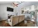 Spacious living room featuring hardwood floors, a ceiling fan, and an open layout at 9919 Memphis St, Commerce City, CO 80022