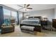 Comfortable main bedroom featuring a ceiling fan, soft carpet, and bright natural light at 9919 Memphis St, Commerce City, CO 80022