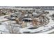 An aerial shot of a neighborhood showcasing homes with snow-covered lawns and driveways at 26531 E Calhoun Pl, Aurora, CO 80016