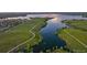 Panoramic aerial showcases a lake with winding trails and lush green spaces at 26531 E Calhoun Pl, Aurora, CO 80016