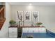 Close-up view of basement wet bar with wine fridge, cabinet storage, wood countertop, and decorative art at 26531 E Calhoun Pl, Aurora, CO 80016