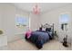 Bright bedroom with a large window, a decorative chandelier, and a cozy bed at 26531 E Calhoun Pl, Aurora, CO 80016