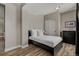 Cozy bedroom with neutral decor, wood-look flooring, and a closet with sliding doors at 26531 E Calhoun Pl, Aurora, CO 80016