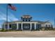 The community's clubhouse features a classic American flag and a clear, bright blue sky at 26531 E Calhoun Pl, Aurora, CO 80016