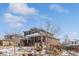 Charming two-story home with a covered front porch and professionally landscaped front yard at 26531 E Calhoun Pl, Aurora, CO 80016