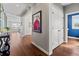 Elegant hallway with hardwood floors, neutral walls, and stylish decor leading to other rooms at 26531 E Calhoun Pl, Aurora, CO 80016