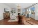 Inviting living room with fireplace, hardwood floors, a chandelier, and bright natural light at 26531 E Calhoun Pl, Aurora, CO 80016