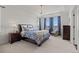 Serene main bedroom featuring a tray ceiling, plush carpet, and a cozy sitting area by the window at 26531 E Calhoun Pl, Aurora, CO 80016