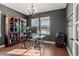 Home office with hardwood floors, gray walls, a modern desk, and natural light from the windows at 26531 E Calhoun Pl, Aurora, CO 80016