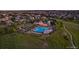 Aerial view showcasing a large community pool, well-maintained landscaping, and seating areas at 26531 E Calhoun Pl, Aurora, CO 80016