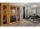 Basement workout area with infrared sauna, exercise bench, weights, and wood-look flooring at 26531 E Calhoun Pl, Aurora, CO 80016