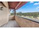 A covered balcony with wood floors and framed by natural views and mountain scenery at 28098 Green Valley Ln, Conifer, CO 80433