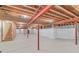 Unfinished basement, framed and ready for customization, with exposed beams and a staircase at 28098 Green Valley Ln, Conifer, CO 80433