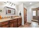 Elegant bathroom features a rustic vanity, tile backsplash, and walk-in shower with tile surround at 28098 Green Valley Ln, Conifer, CO 80433