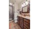Bathroom features copper sink, decorative mirror, tile floors, and walk-in shower at 28098 Green Valley Ln, Conifer, CO 80433