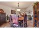 Dining room with a large wooden table, decorative chandelier, and tile flooring at 28098 Green Valley Ln, Conifer, CO 80433