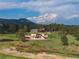 Expansive property with a modern house, pond, outbuildings, trees, and lush grounds at 28098 Green Valley Ln, Conifer, CO 80433