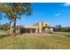 Tan two-story home with a three-car garage and mountain views at 28098 Green Valley Ln, Conifer, CO 80433