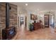 Hallway with ceramic tile flooring, decorative accents, and wood-burning stove at 28098 Green Valley Ln, Conifer, CO 80433