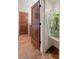 Hallway with ceramic tile flooring, wood accents, and a large doorway at 28098 Green Valley Ln, Conifer, CO 80433
