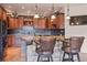 Kitchen with tile backsplash, granite countertops, dark wood cabinets, and breakfast bar at 28098 Green Valley Ln, Conifer, CO 80433