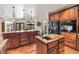 A spacious kitchen boasts custom wood cabinets, granite countertops, and a center island at 28098 Green Valley Ln, Conifer, CO 80433