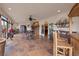 Open living space with tile floors, beamed ceiling, and Cantina-style wet bar at 28098 Green Valley Ln, Conifer, CO 80433
