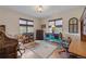 Office room boasts natural light from two windows and rustic furniture at 28098 Green Valley Ln, Conifer, CO 80433