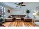 Spacious living room featuring a brown leather sectional sofa and hardwood floors at 3500 W 55Th Ave, Denver, CO 80221