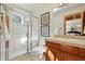 Bathroom with a glass enclosed shower, neutral colored tiles, and modern vanity at 9041 Eastridge Rd, Golden, CO 80403