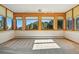 Bright and airy bedroom featuring large windows with scenic mountain views and neutral carpeting for a cozy feel at 9041 Eastridge Rd, Golden, CO 80403