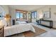 Serene bedroom with large windows, window seating, balcony access, and neutral tones, creating a peaceful retreat at 9041 Eastridge Rd, Golden, CO 80403