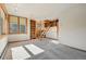 Spacious bedroom featuring built-in bookshelves, a rolling ladder, large windows, and neutral carpeting for a cozy feel at 9041 Eastridge Rd, Golden, CO 80403