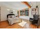 Cozy bedroom with hardwood floors, natural light, and exposed wood beams at 9041 Eastridge Rd, Golden, CO 80403