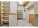 Walk-in closet featuring built-in shelving and ample storage space at 9041 Eastridge Rd, Golden, CO 80403