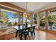 Bright dining area with a scenic view and rustic dining set at 9041 Eastridge Rd, Golden, CO 80403