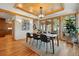 Charming dining room with wood-clad ceiling, modern lighting, large windows, and access to the adjacent kitchen at 9041 Eastridge Rd, Golden, CO 80403