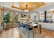Open dining area with wood floors, large windows, and a stylish light fixture at 9041 Eastridge Rd, Golden, CO 80403