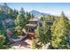 Beautiful home exterior nestled in a lush, green landscape with views of the mountains in the background at 9041 Eastridge Rd, Golden, CO 80403