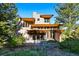 Modern home with unique architectural design and natural wood accents, surrounded by lush greenery at 9041 Eastridge Rd, Golden, CO 80403