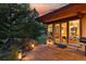 Back patio showcasing outdoor lighting, dining area, and large windows with a charming blend of modern and natural elements at 9041 Eastridge Rd, Golden, CO 80403