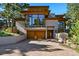 Striking modern home with a brick driveway, large windows, and beautiful wood accents at 9041 Eastridge Rd, Golden, CO 80403