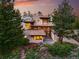Modern home exterior surrounded by mature trees featuring unique architectural design and wood accents at 9041 Eastridge Rd, Golden, CO 80403