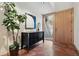 Welcoming foyer features a sleek black console table, stylish artwork, and a modern light wood front door with sidelight at 9041 Eastridge Rd, Golden, CO 80403