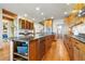 Spacious kitchen featuring wood cabinets, granite countertops, stainless steel appliances, and an inviting kitchen island at 9041 Eastridge Rd, Golden, CO 80403