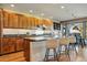Bright kitchen with wood cabinets, granite countertops, and counter seating at 9041 Eastridge Rd, Golden, CO 80403